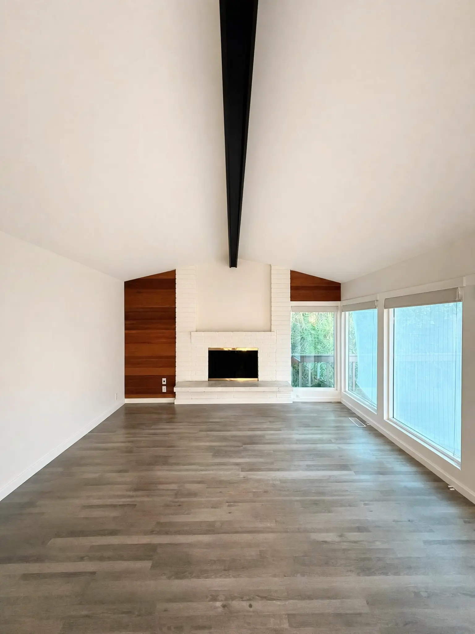 Full interior living room repainting with white vaulted ceiling and painted fireplace in Sammamish, WA
